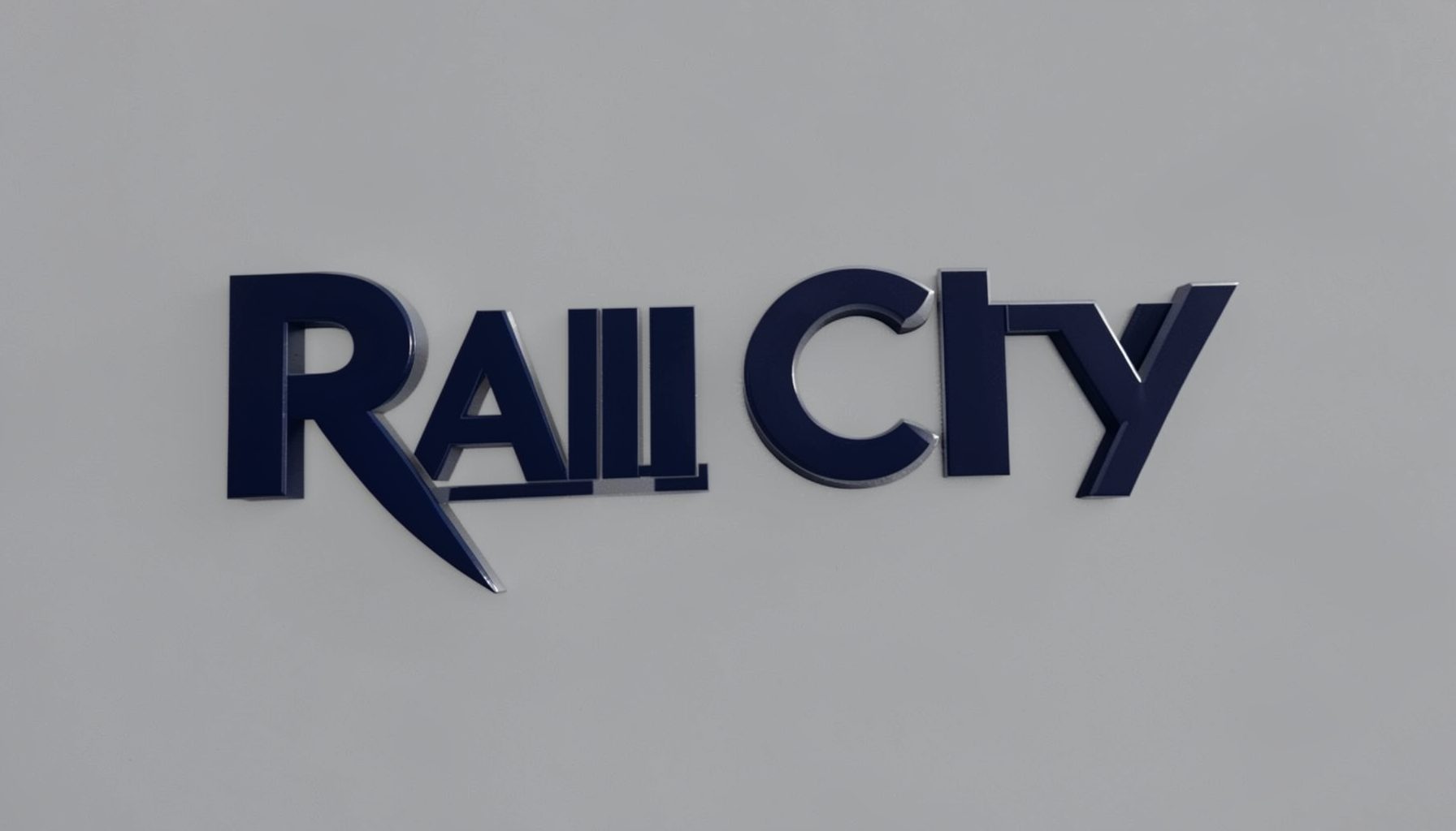 Rain City Video logo — a moody, film-reel-inspired mark in deep navy and muted silver against a soft gray background
